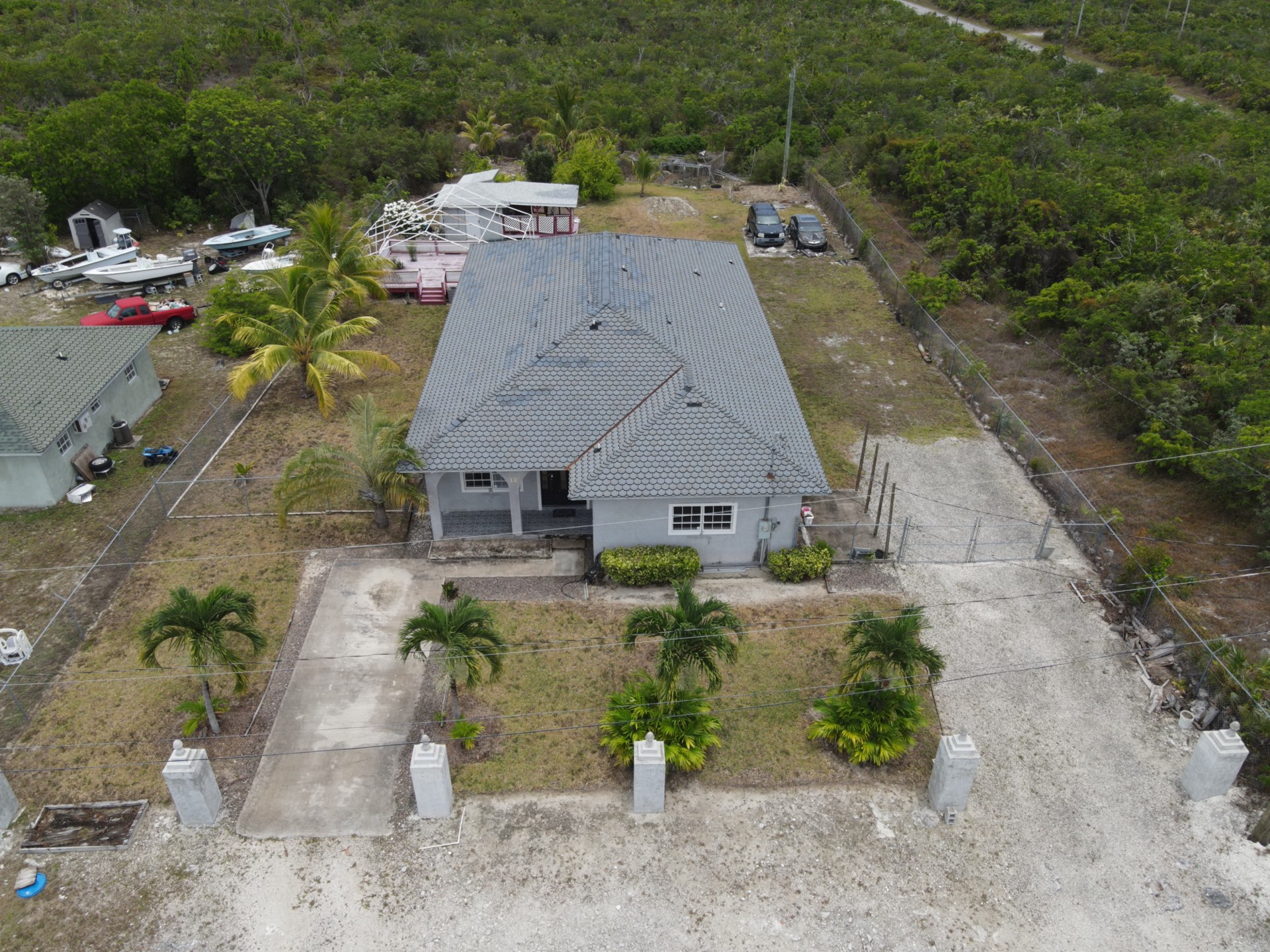Single-family home with grey shingle roof and columned porch, Arden Forest