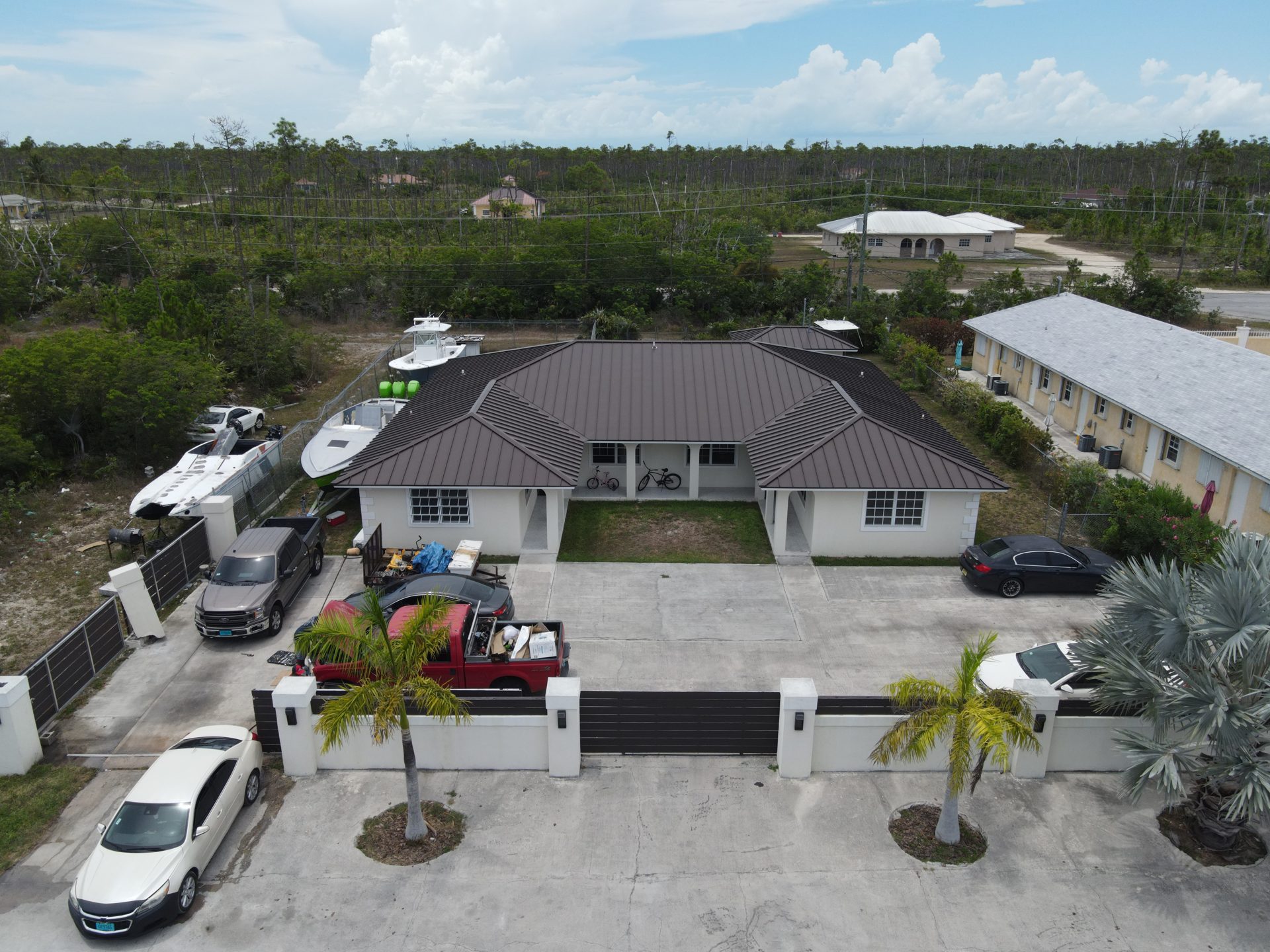 Completed duplex with brown standing-seam metal roof, Grand Bahama