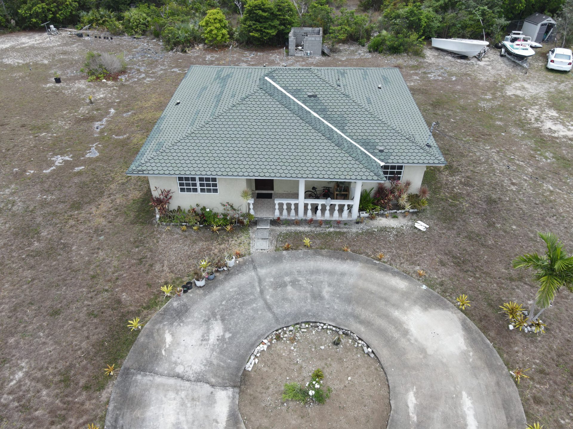 Single-family home with tile roof and columned porch, Grand Bahama